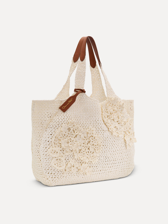 White Topaz in Crochet Raffia with white leather handle and crochet embroidered flower motifs. Side View.