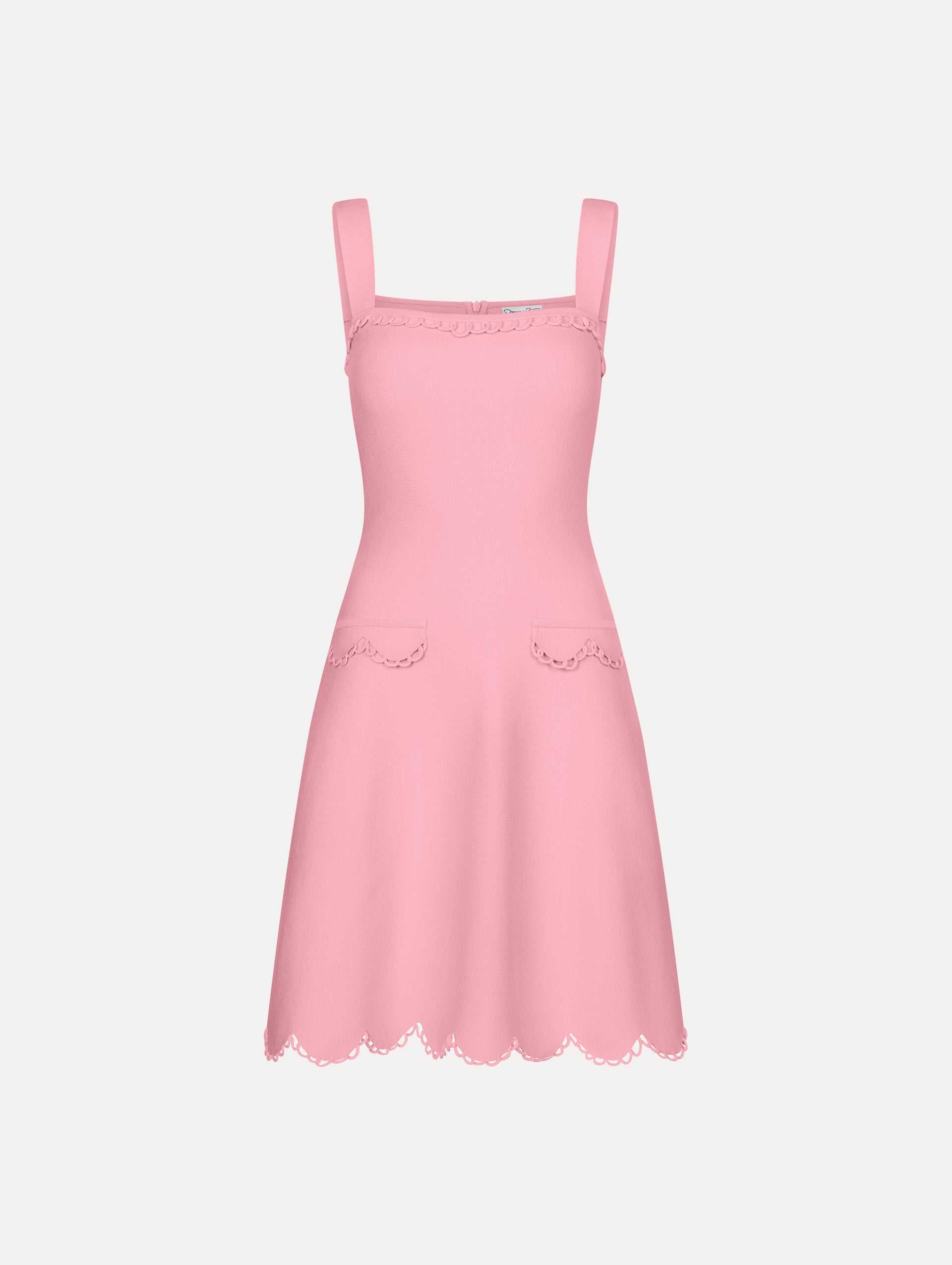 Pink mini dress with thick tank top straps, front flap pockets, and scalloped lace trim.