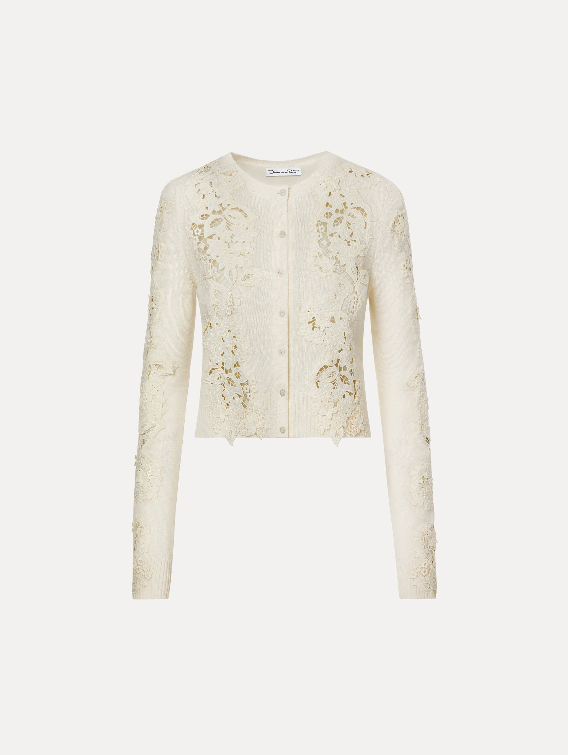 Long-sleeve cardigan in the color Ivory with button front and cutout lace detail.