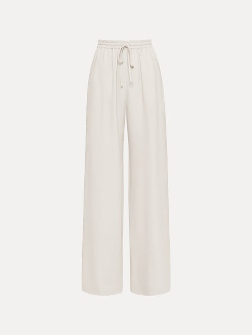 The Silk Georgette Drawstring Pant in the color ivory featuring straight, wide-legs and an elastic waistband finished with a drawstring tie. Front View.