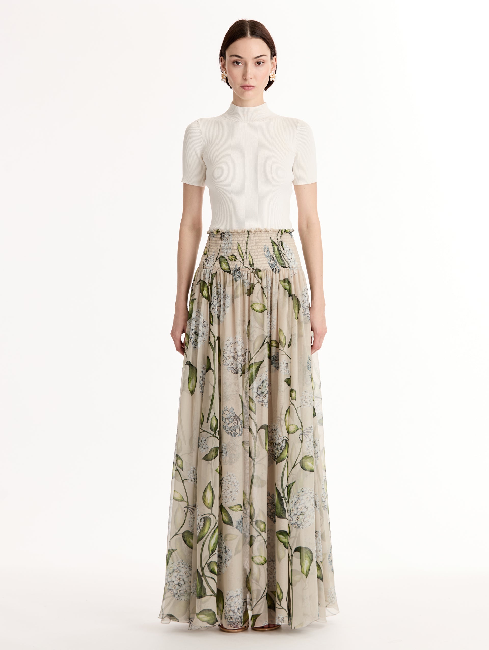 Oatmeal Porcelain Flower Chiffon Maxi Skirt featuring a smocked high waist and a flowing A-line silhouette with green and blue floral print. Front View.