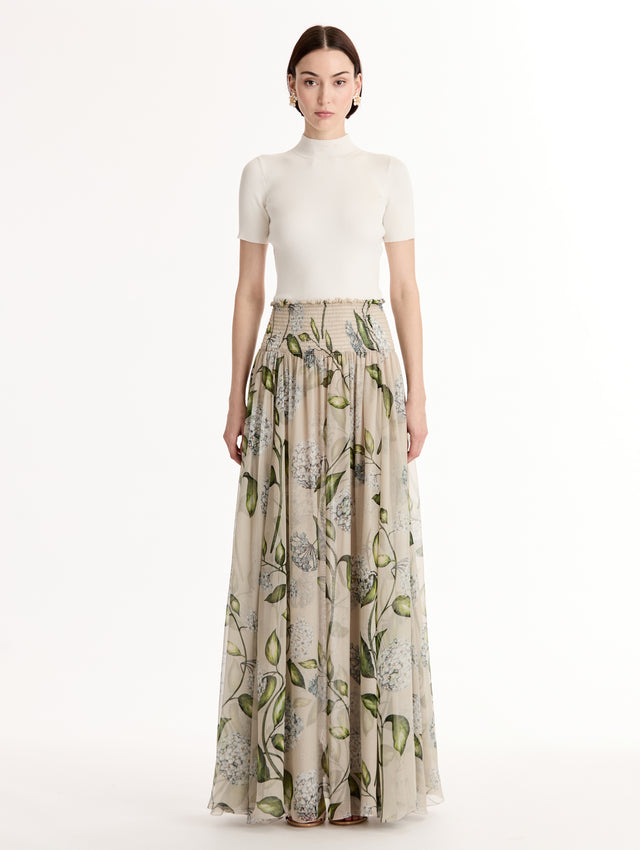 Oatmeal Porcelain Flower Chiffon Maxi Skirt featuring a smocked high waist and a flowing A-line silhouette with green and blue floral print. Front View.