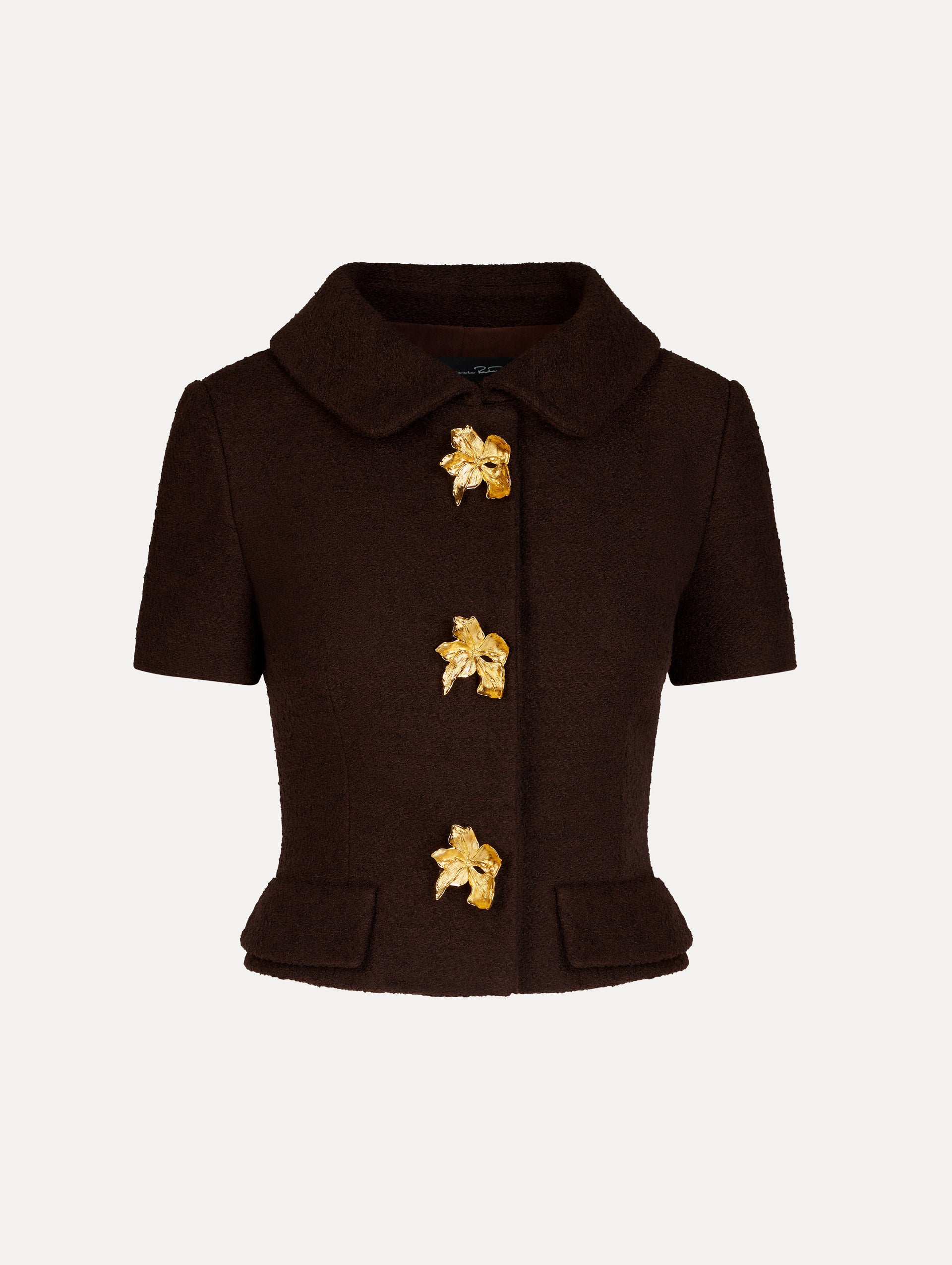Blouse in the color Mahogany Brown, featuring a tailored cut, front flap pockets, classic collar neckline, short sleeves, and gold flower button center.