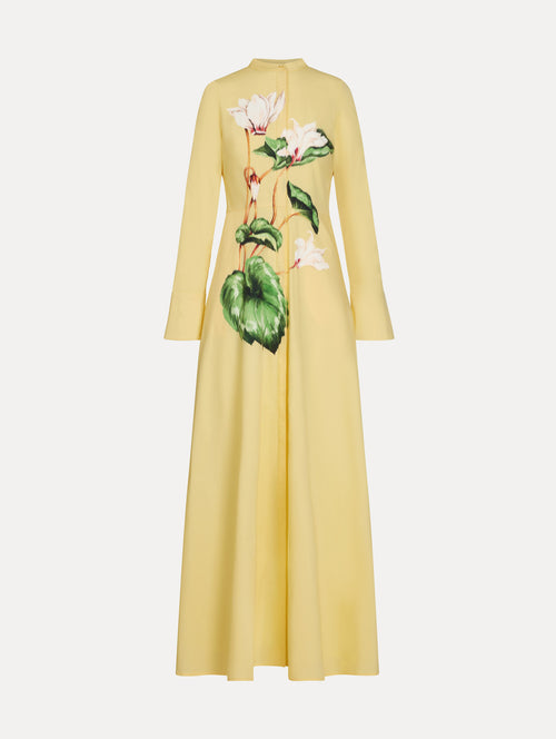 Yellow cotton poplin caftan with a mandarin collar and concealed button front. Chiné Cyclamen motif softly blurred, edges. Full-length sleeves. Front View. 