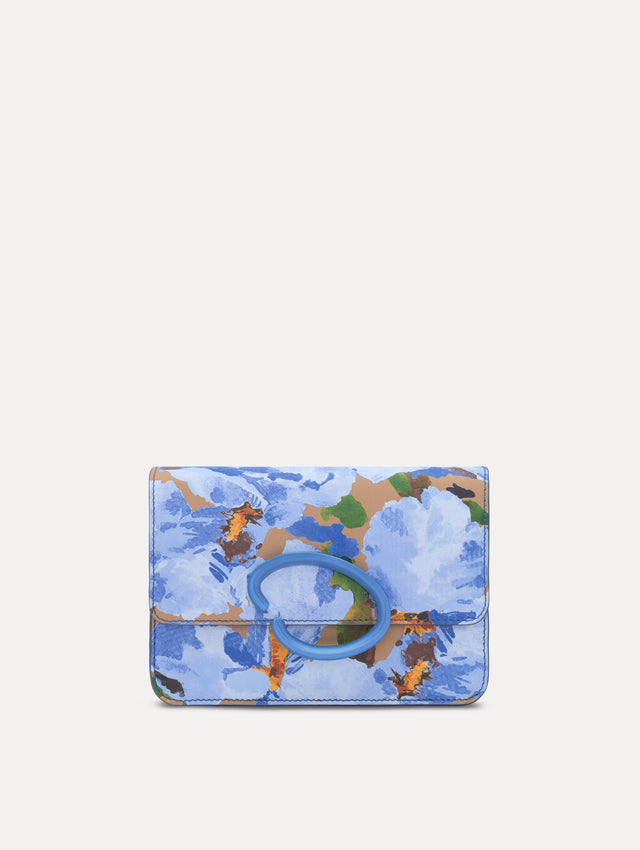 The model is carrying an iris printed saffiano O pochette. Side view.