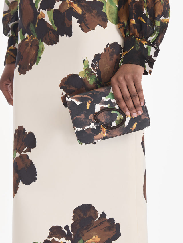 The model is carrying an iris printed saffiano O pochette. Front view.