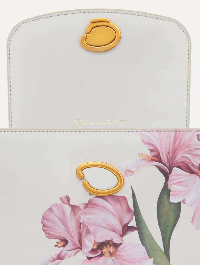 The model is carrying an iris printed mini poppy. Zoom view.