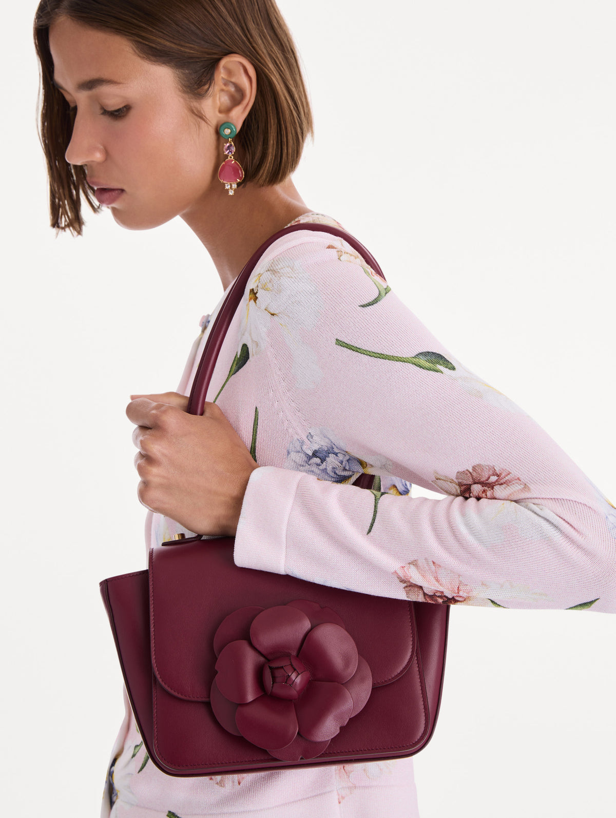 The model is carrying a top handle TRO bag. Front view.