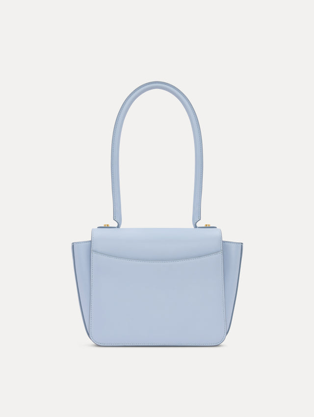 The model is carrying a top handle TRO bag. Front view.