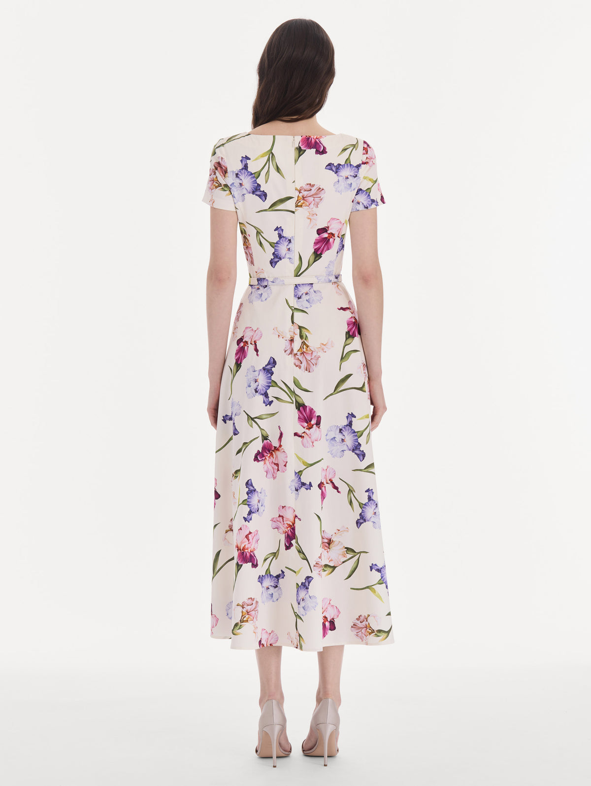 The model is wearing a short sleeve iris flowers poplin day dress. Back view.