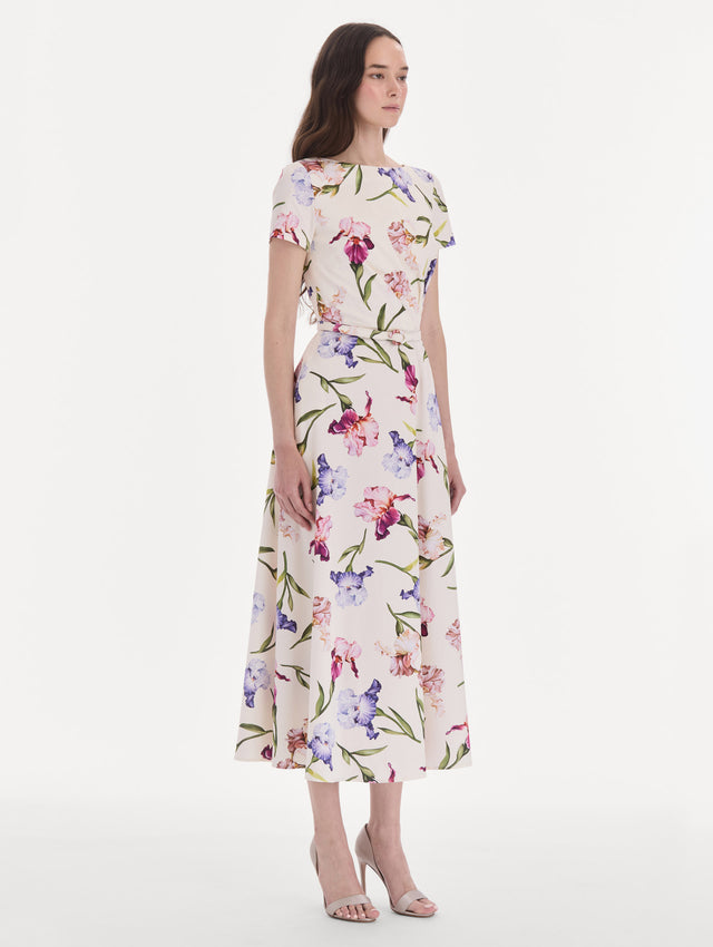 The model is wearing a short sleeve iris flowers poplin day dress. Side view.