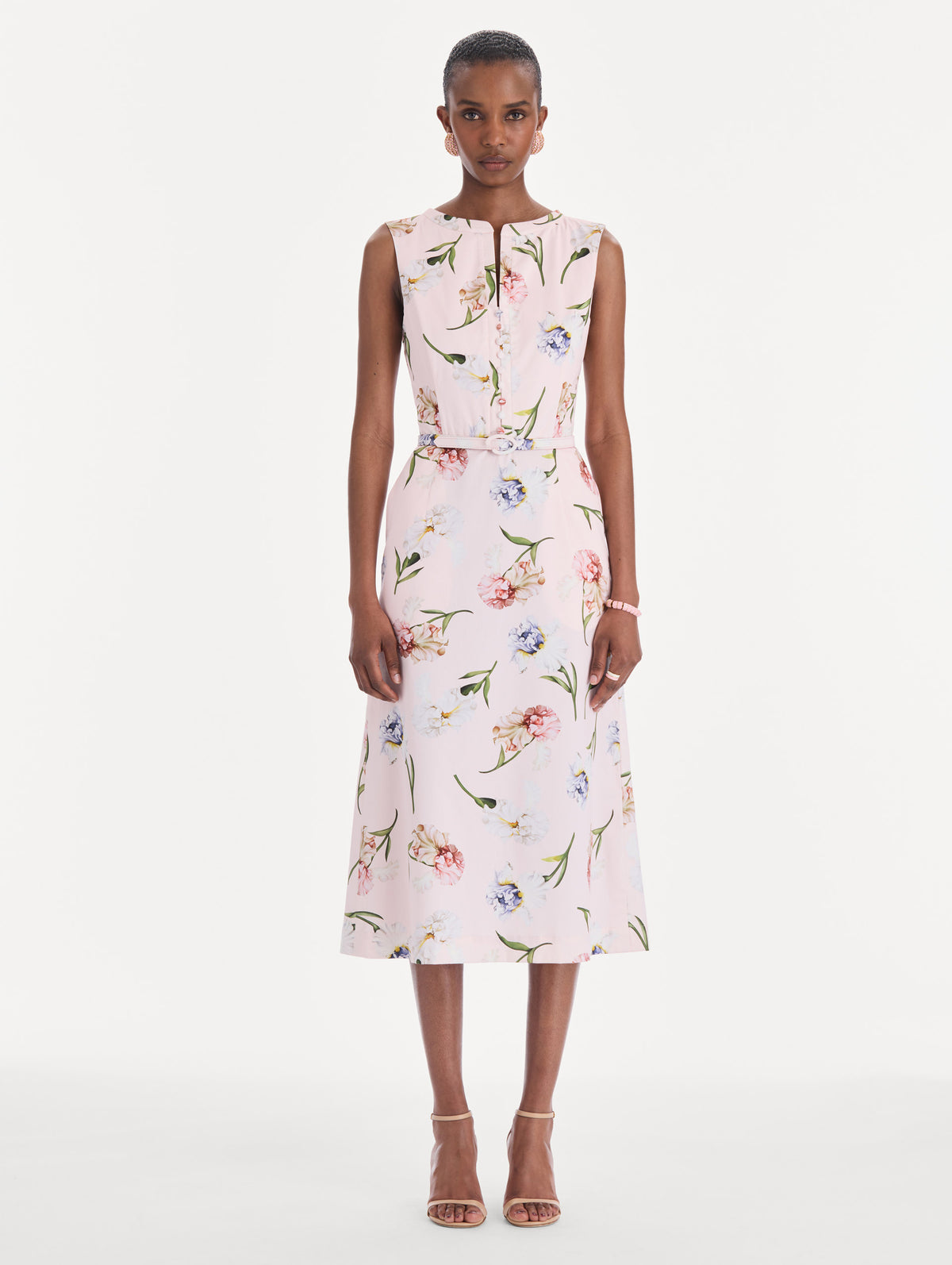 The model is wearing a sleeveless painted iris poplin day dress. Front view.