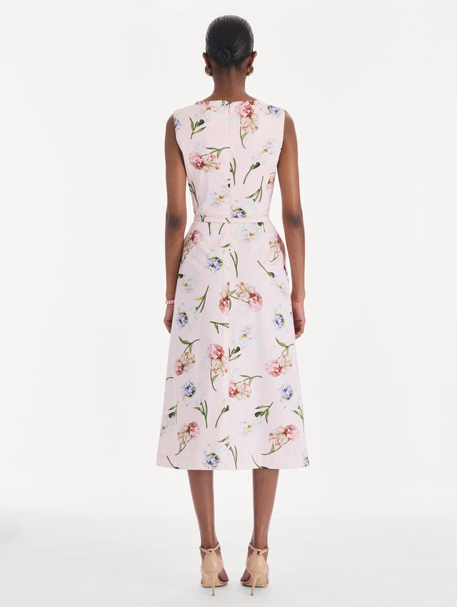 The model is wearing a sleeveless painted iris poplin day dress. Back view.