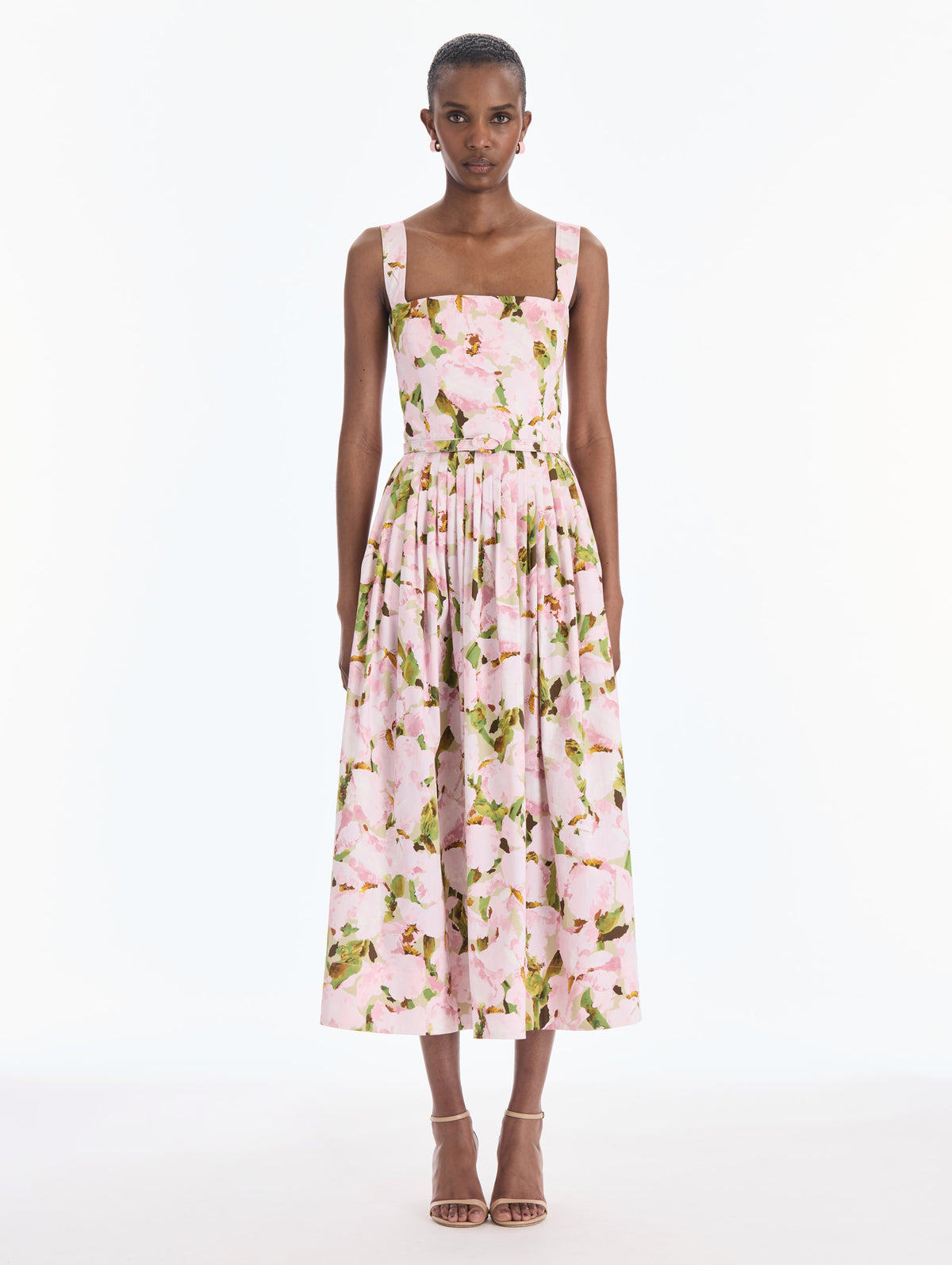 The model is wearing a sleeveless watercolor iris poplin day dress. Front view.