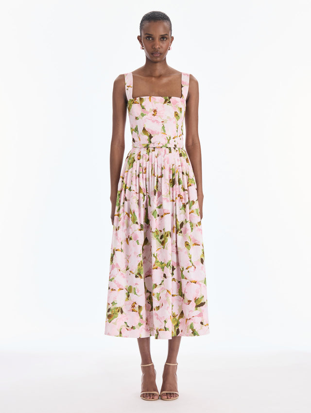 The model is wearing a sleeveless watercolor iris poplin day dress. Front view.