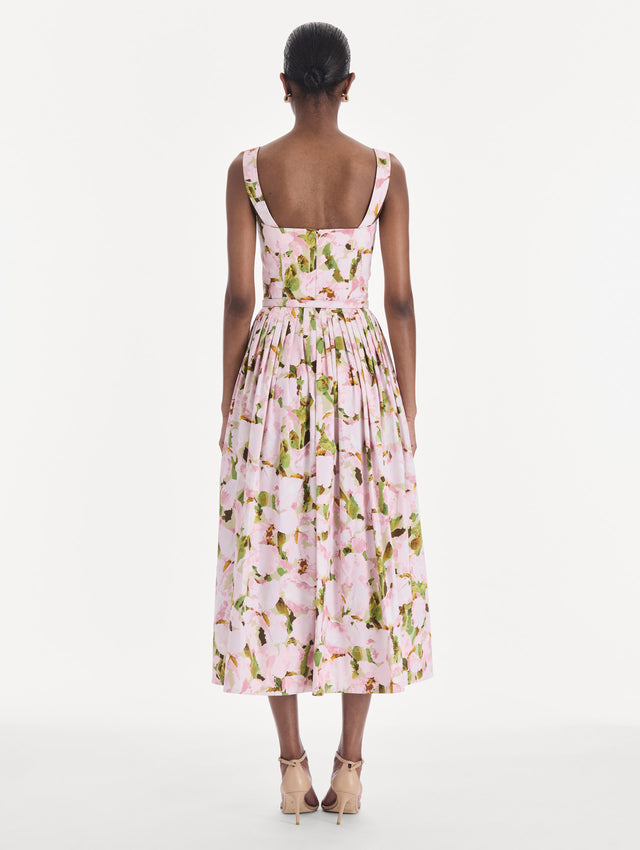 The model is wearing a sleeveless watercolor iris poplin day dress. Back view.