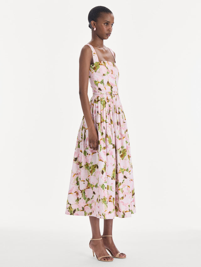 The model is wearing a sleeveless watercolor iris poplin day dress. Side view.