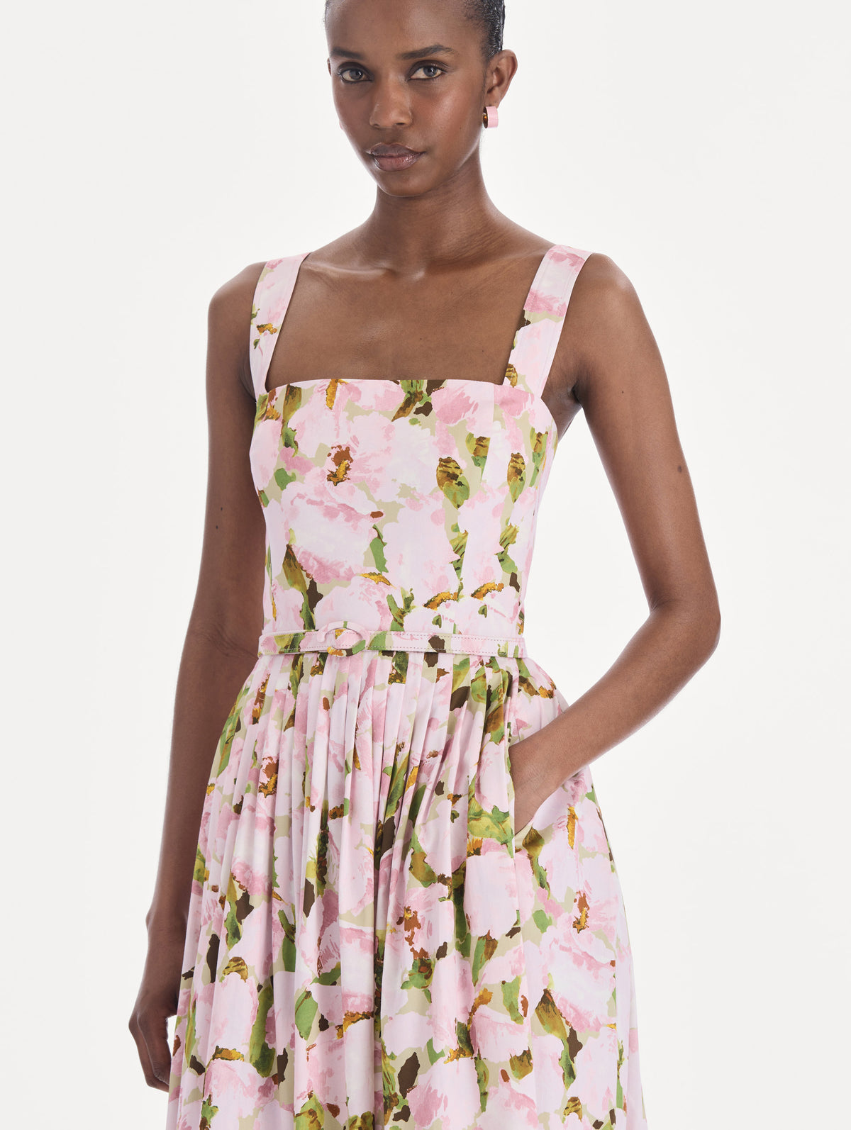 The model is wearing a sleeveless watercolor iris poplin day dress. Zoom view.