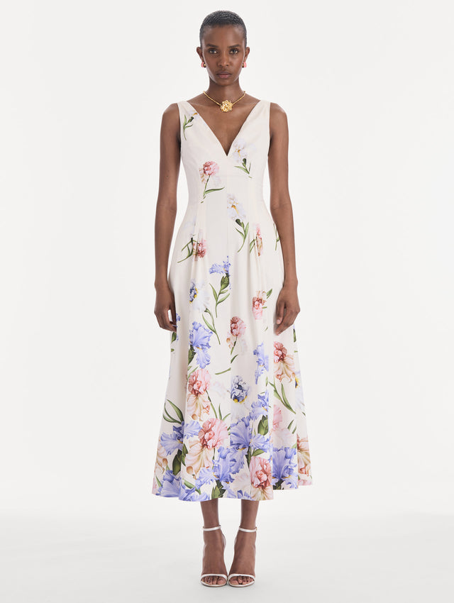 The model is wearing a sleeveless V-neck large iris degrade poplin dress. Front view.