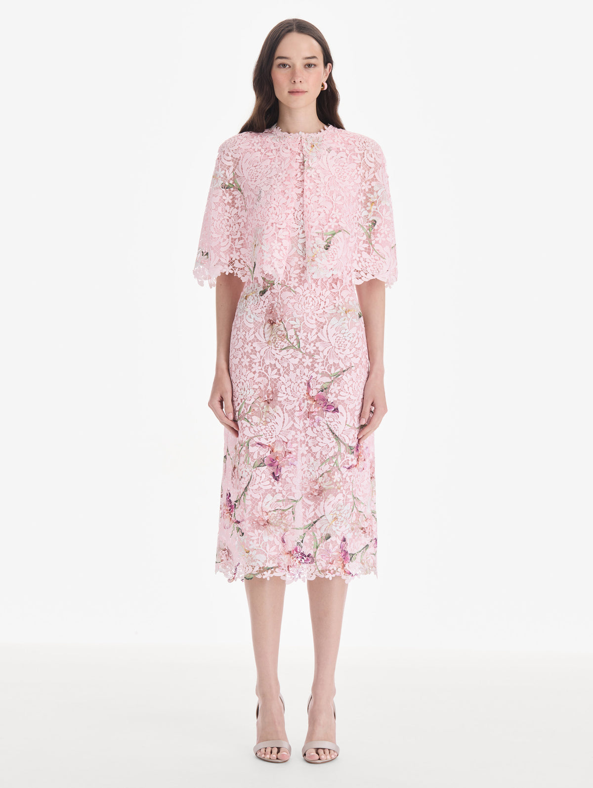 The model is wearing a cape sleeve painted iris degrade lace day dress. Back view.