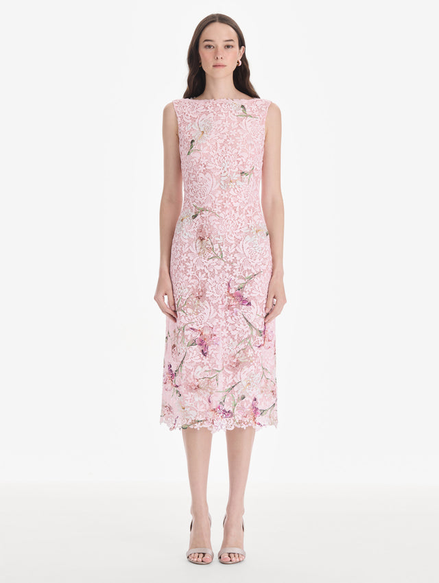 The model is wearing a cape sleeve painted iris degrade lace day dress. Side view.