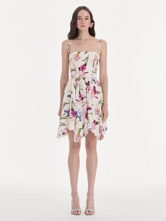 The model is wearing a sleeveless iris flowers poplin day dress. Front view.