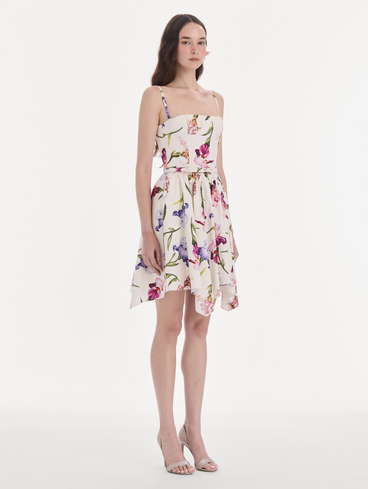 The model is wearing a sleeveless iris flowers poplin day dress. Side view.