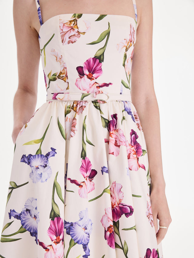 The model is wearing a sleeveless iris flowers poplin day dress. Zoom view.