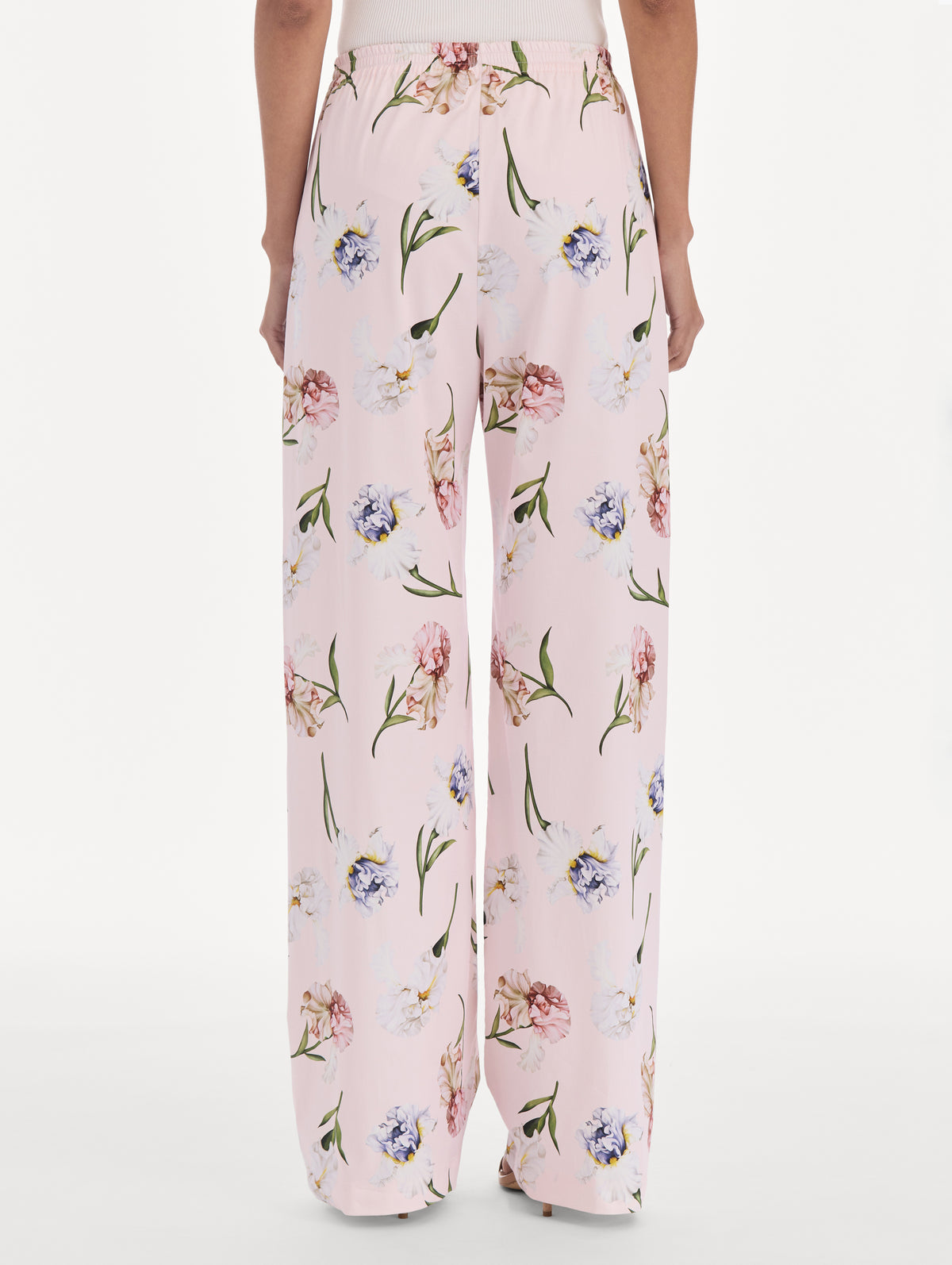 The model is wearing a painted iris poplin pant. Back view.