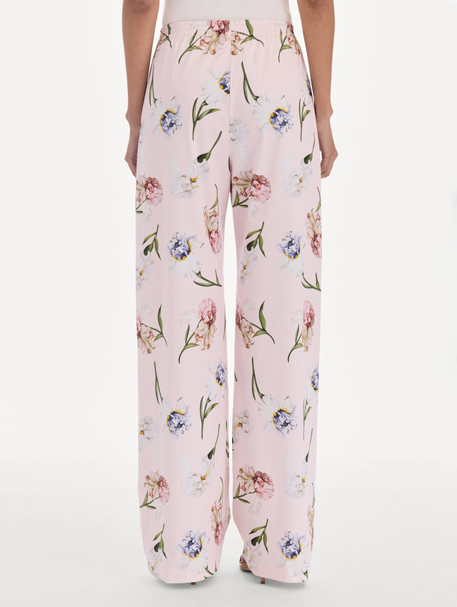 The model is wearing a painted iris poplin pant. Back view.