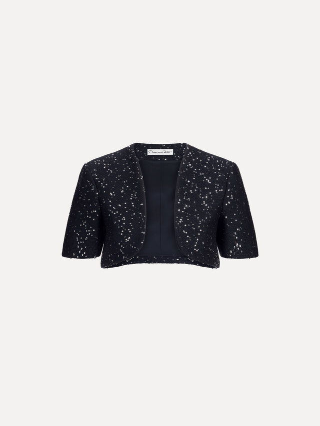 The image depicts a short sleeve sequin tweed cape. Front view.