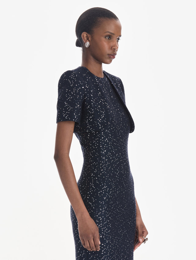 The model is wearing a short sleeve sequin tweed cape. Zoom view.