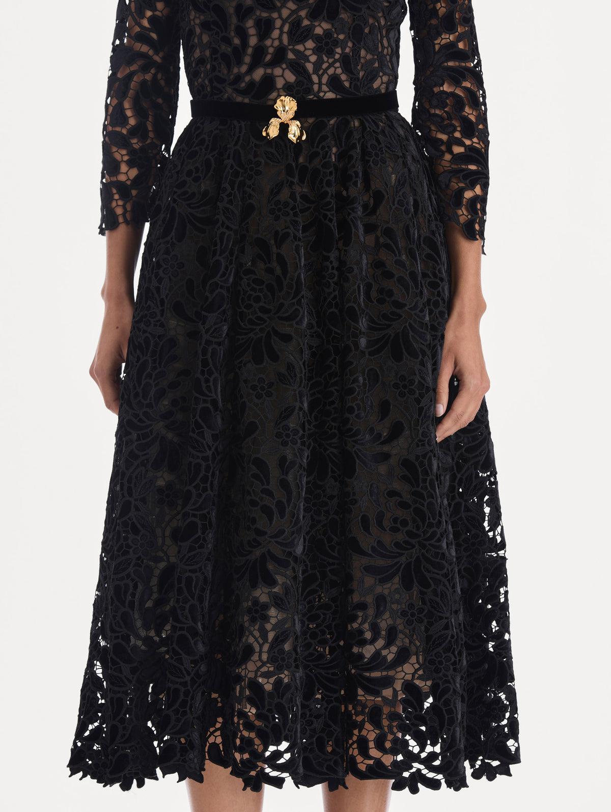 The model is wearing a long sleeve chrysanthemum guipure cocktail dress. Zoom view.