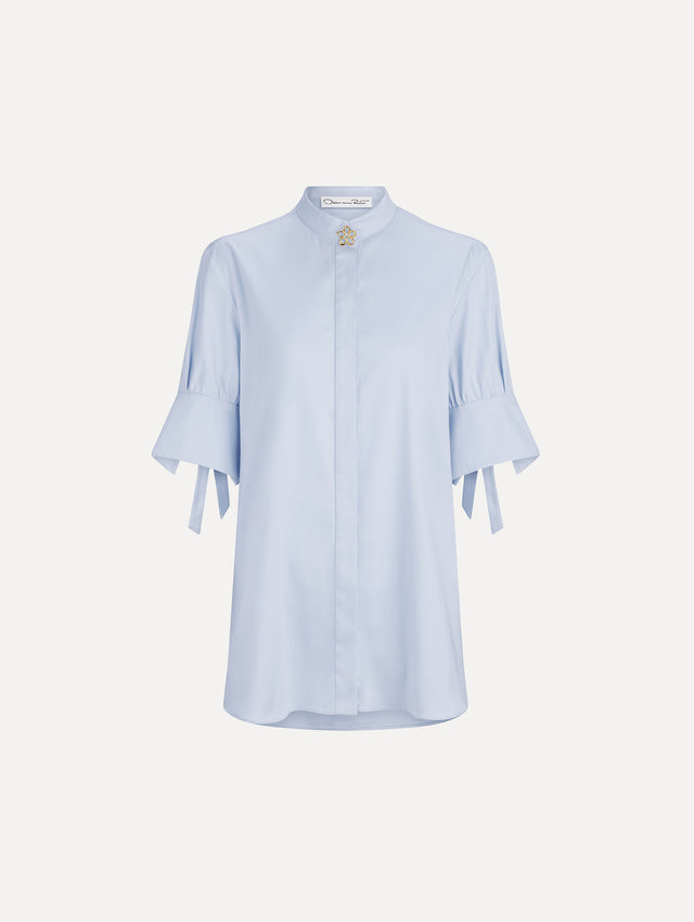 The image depicts a short sleeve cotton poplin sateen blouse. Front view.