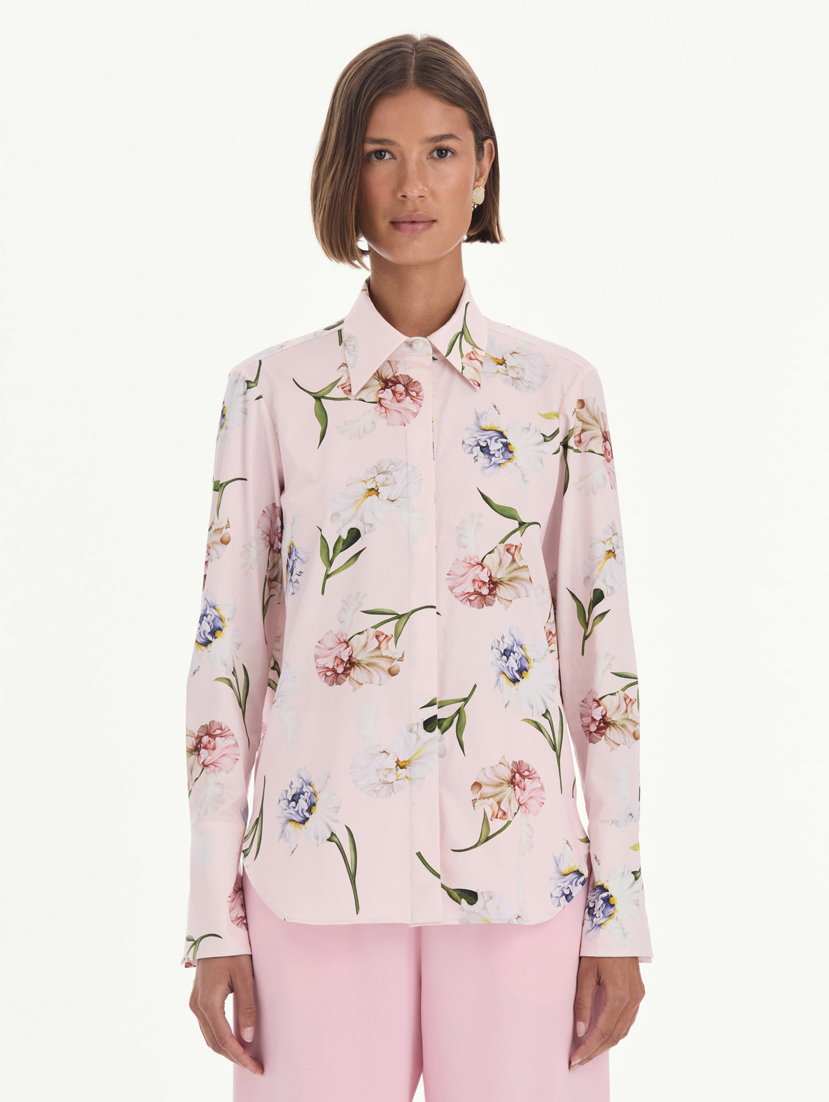The model is wearing a long sleeve painted iris poplin blouse. Front view.