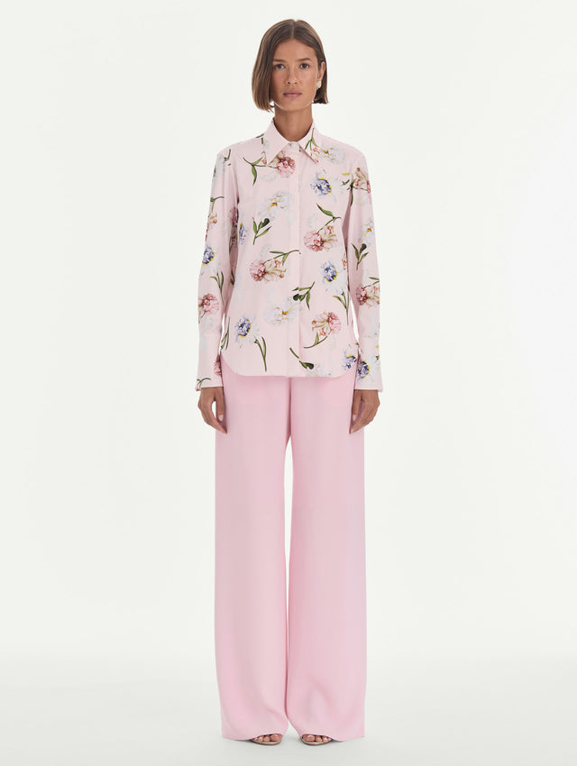 The model is wearing a long sleeve painted iris poplin blouse. Front view.