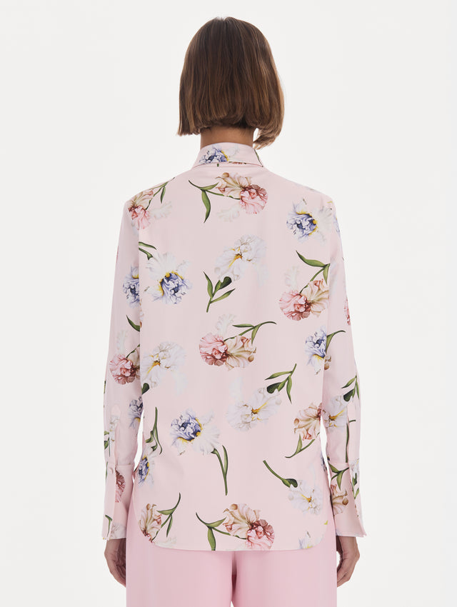 The model is wearing a long sleeve painted iris poplin blouse. Back view.