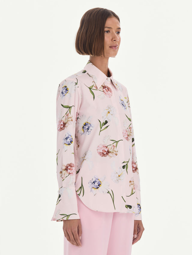 The model is wearing a long sleeve painted iris poplin blouse. Side view.
