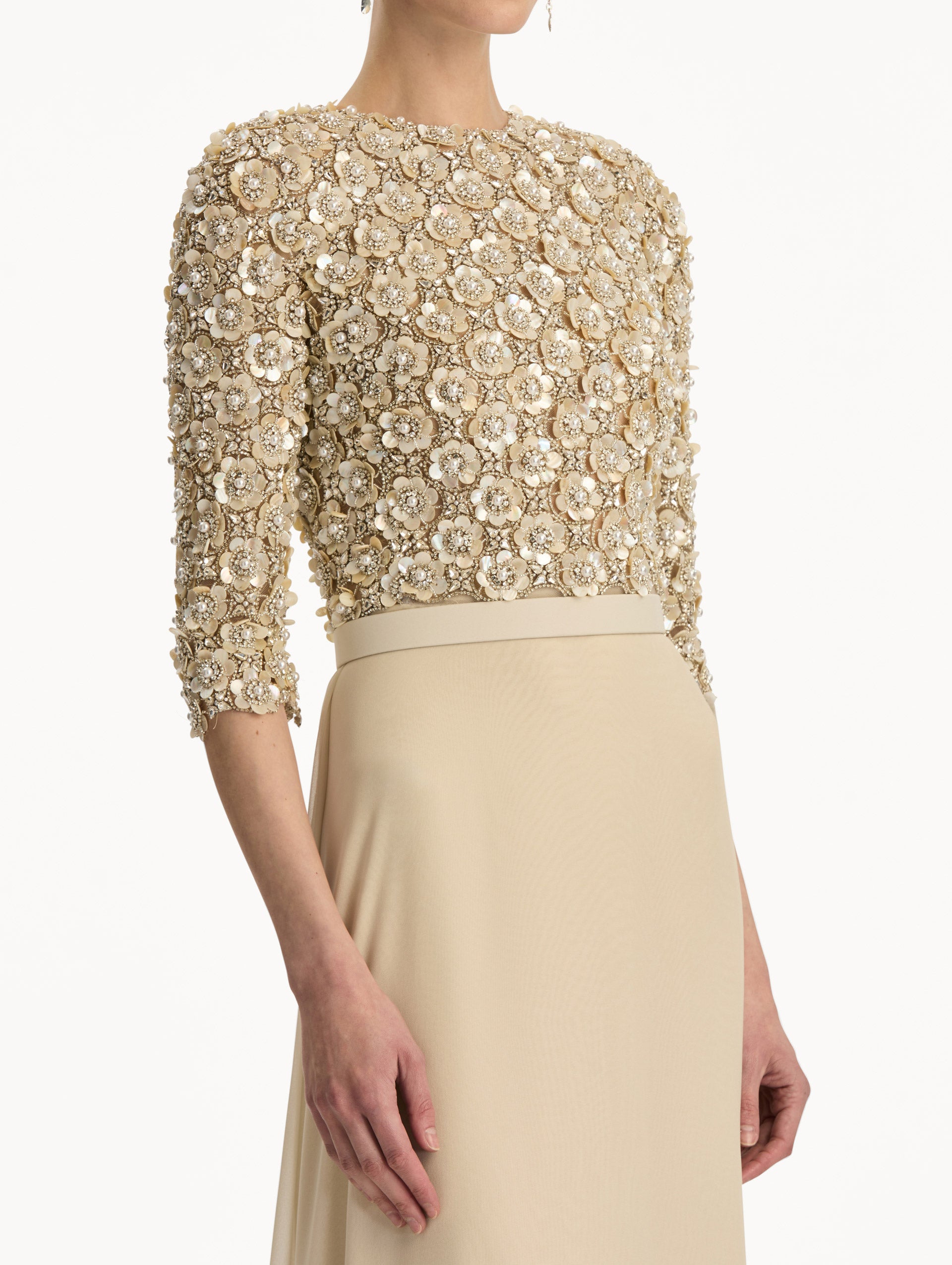 Bone Mother of Pearl Embroidered Gown with long, belted skirt and long sleeve embroidered bodice. Zoom View.