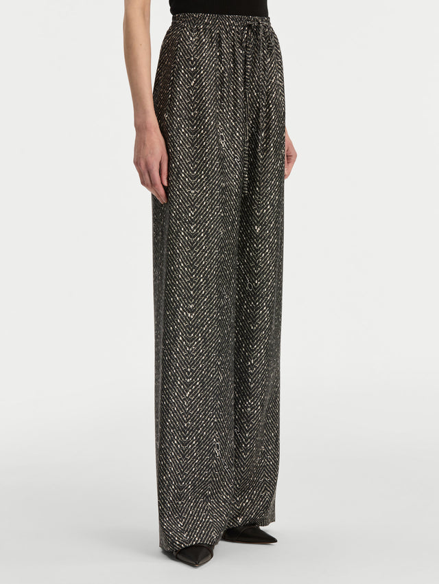Black and Ivory Chevron Silk Twill Drawstring Pant featuring a high elastic waistband and fluid, shimmering drape. Side View.
