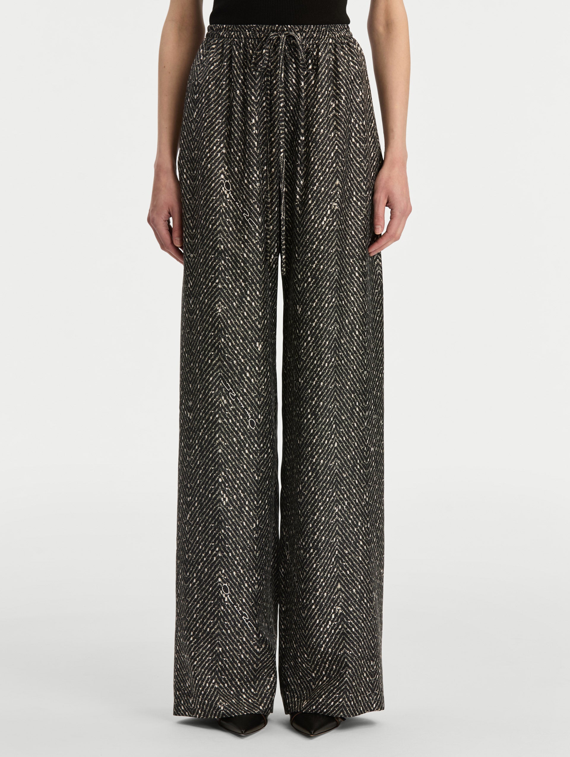 Black and Ivory Chevron Silk Twill Drawstring Pant featuring a high elastic waistband and fluid, shimmering drape. Front View.