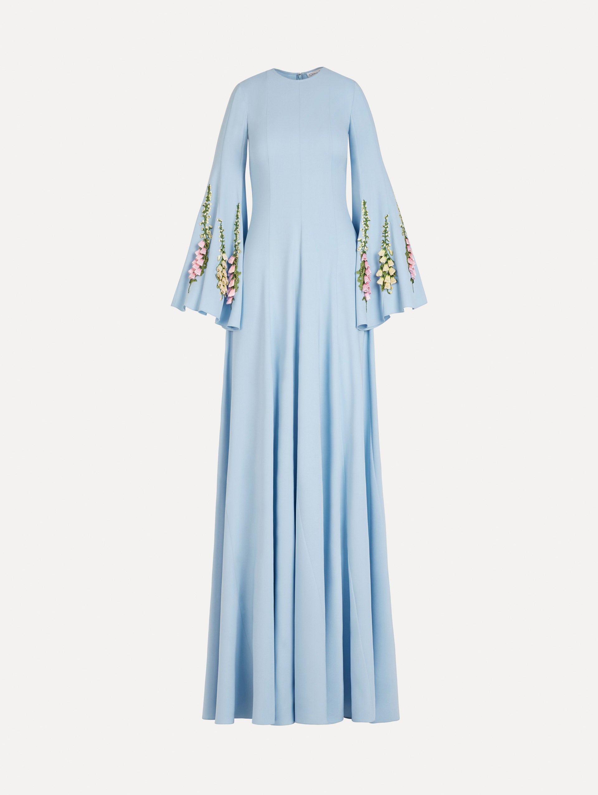 The Foxglove Embroidered Bell Sleeve Caftan in light blue featuring a floor-sweeping hemline and wide, bell sleeves embroidered with floral motifs. Front View.