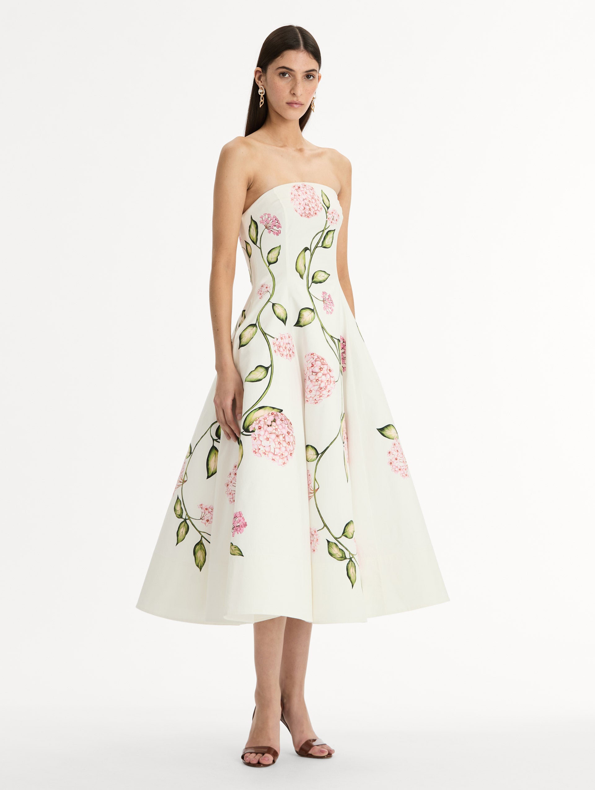 White, strapless cotton poplin midi dress.  Sculpted bodice with flared skirt. vivid pink flower print. Side View. 