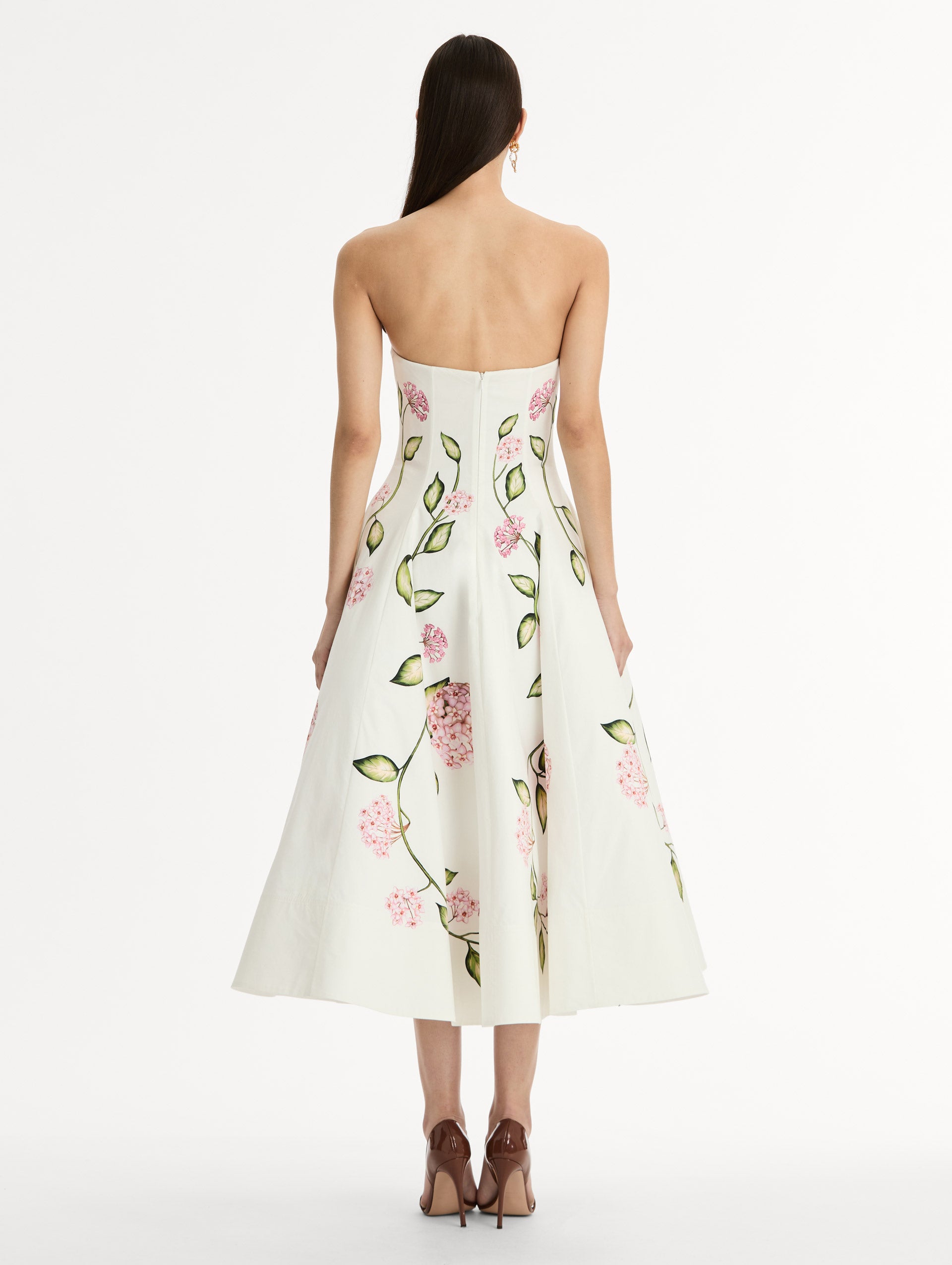 White, strapless cotton poplin midi dress.  Sculpted bodice with flared skirt. vivid pink flower print. Back View. 