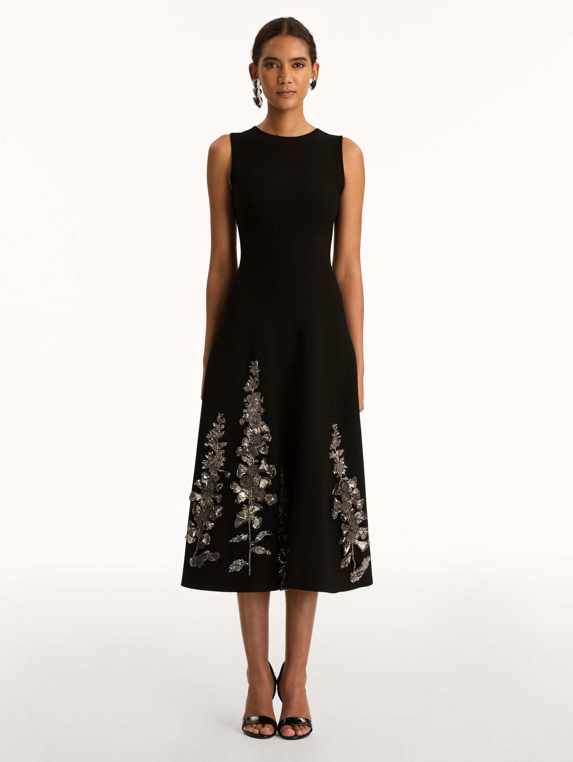 Black Foxglove Sequin Embroidered Knit Dress featuring a round neckline and silver floral embroidery along the skirt. Front View.