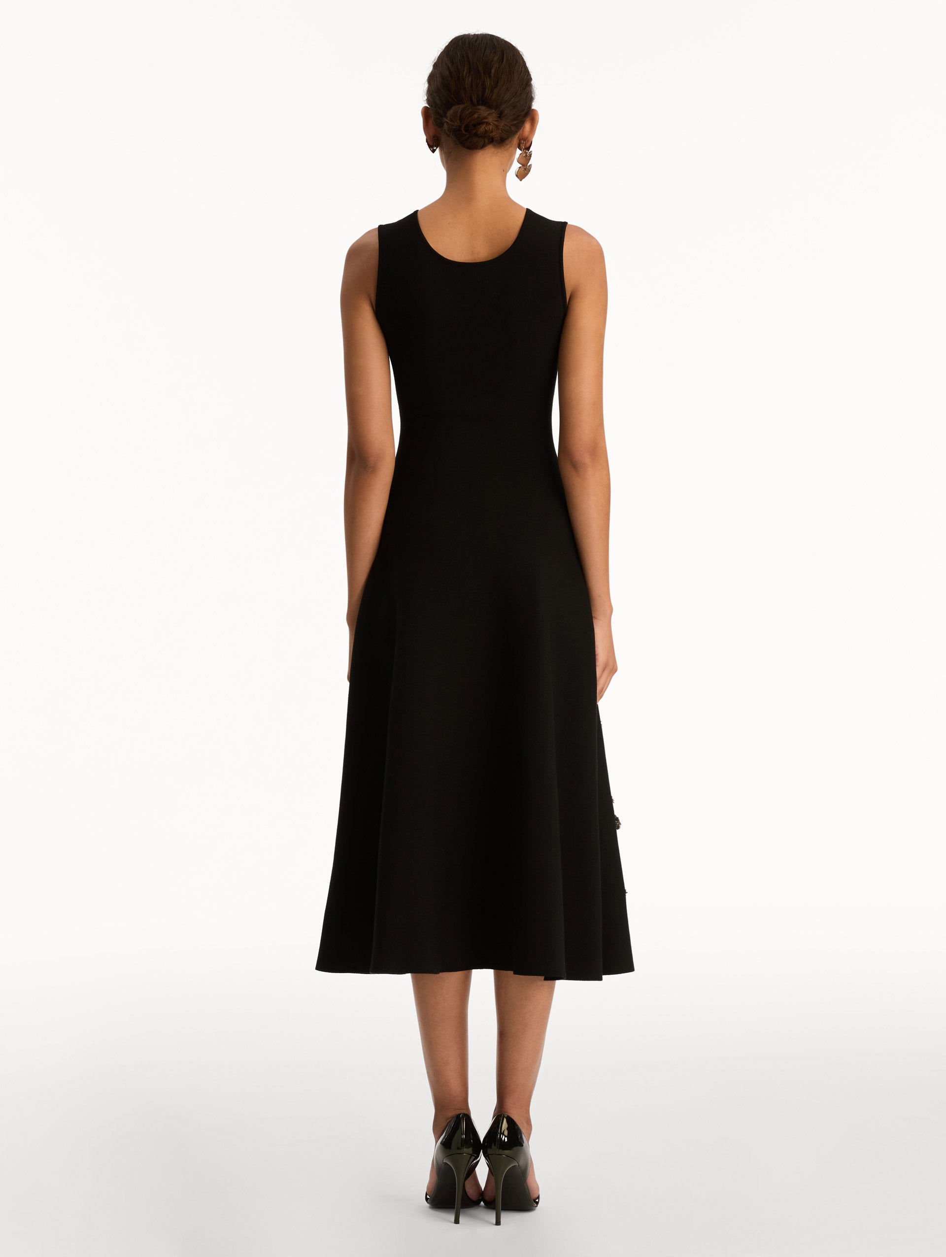 Black Foxglove Sequin Embroidered Knit Dress featuring a round neckline and silver floral embroidery along the skirt. Back View.