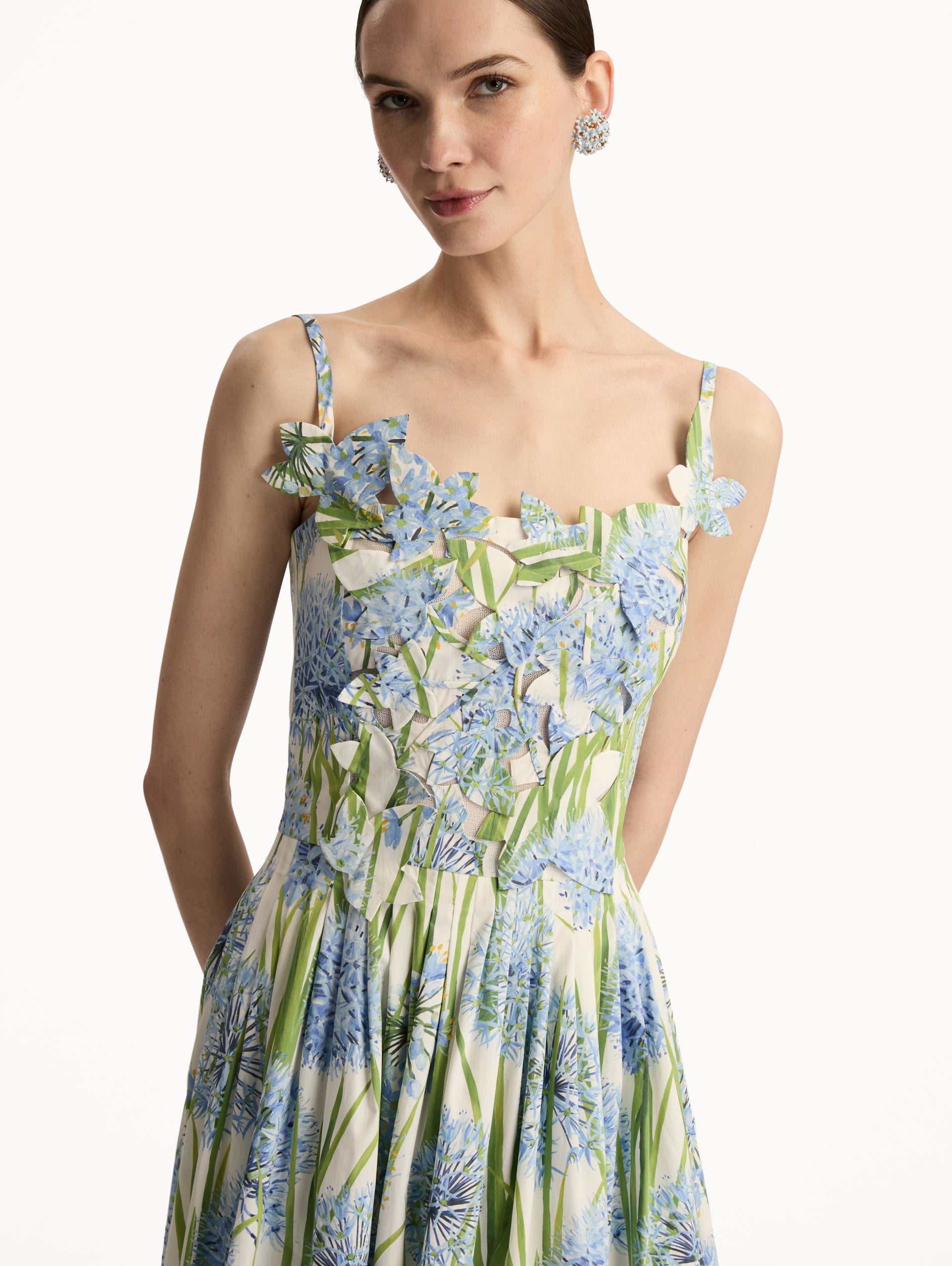 White Allium Embroidered Cotton Poplin Dress with blue floral print, fitted bodice, and embellished flower applique on the neckline. Zoom View.