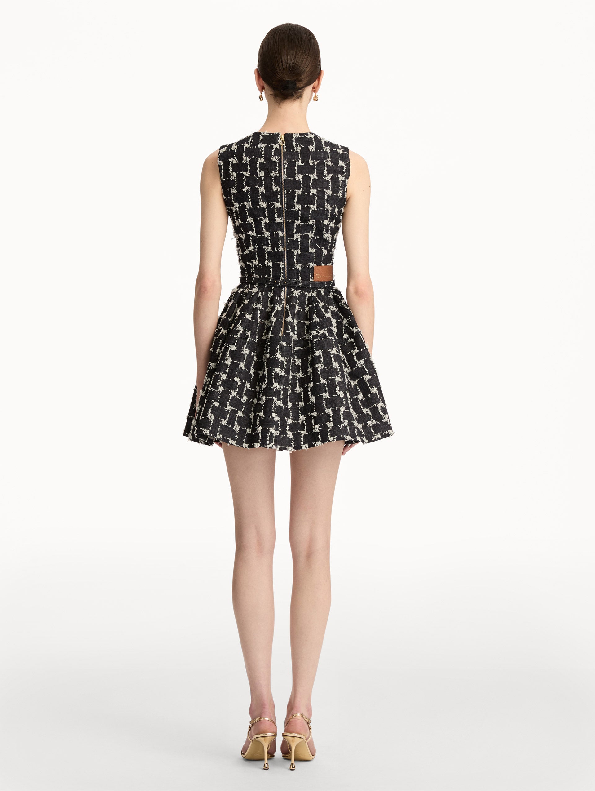 Black and Ivory Woven Denim Jacquard Mini Dress with a fitted waist, flared skirt, and gold floral belt detail. Back View.
