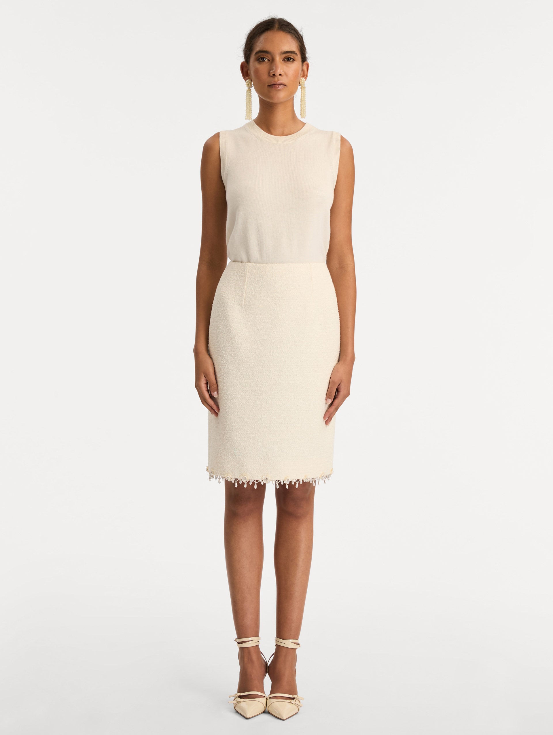 White Floral Jeweled Fringe Tweed Skirt featuring a fitted silhouette with jeweled applique along hem. Front View.