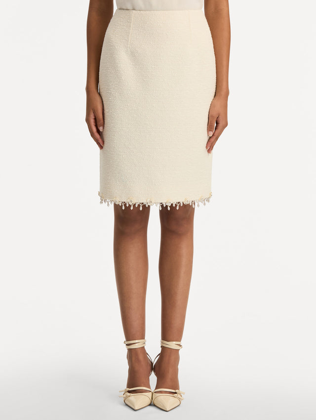 White Floral Jeweled Fringe Tweed Skirt featuring a fitted silhouette with jeweled applique along hem. Front View.